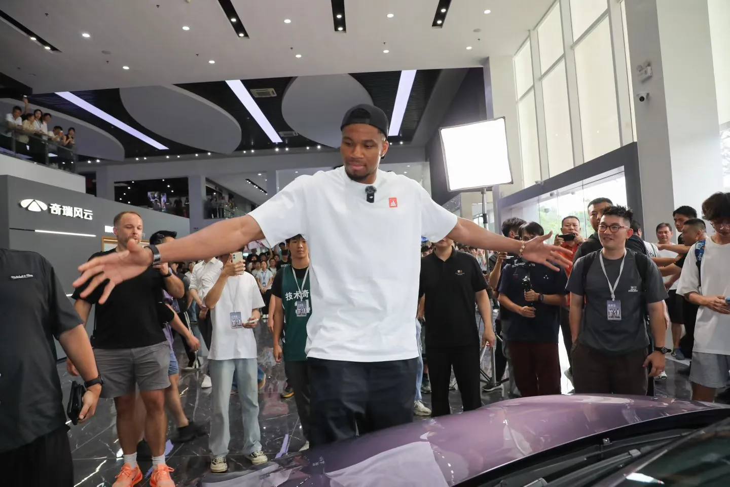 Giannis Antetokounmpo greeting fans in a Chery showroom