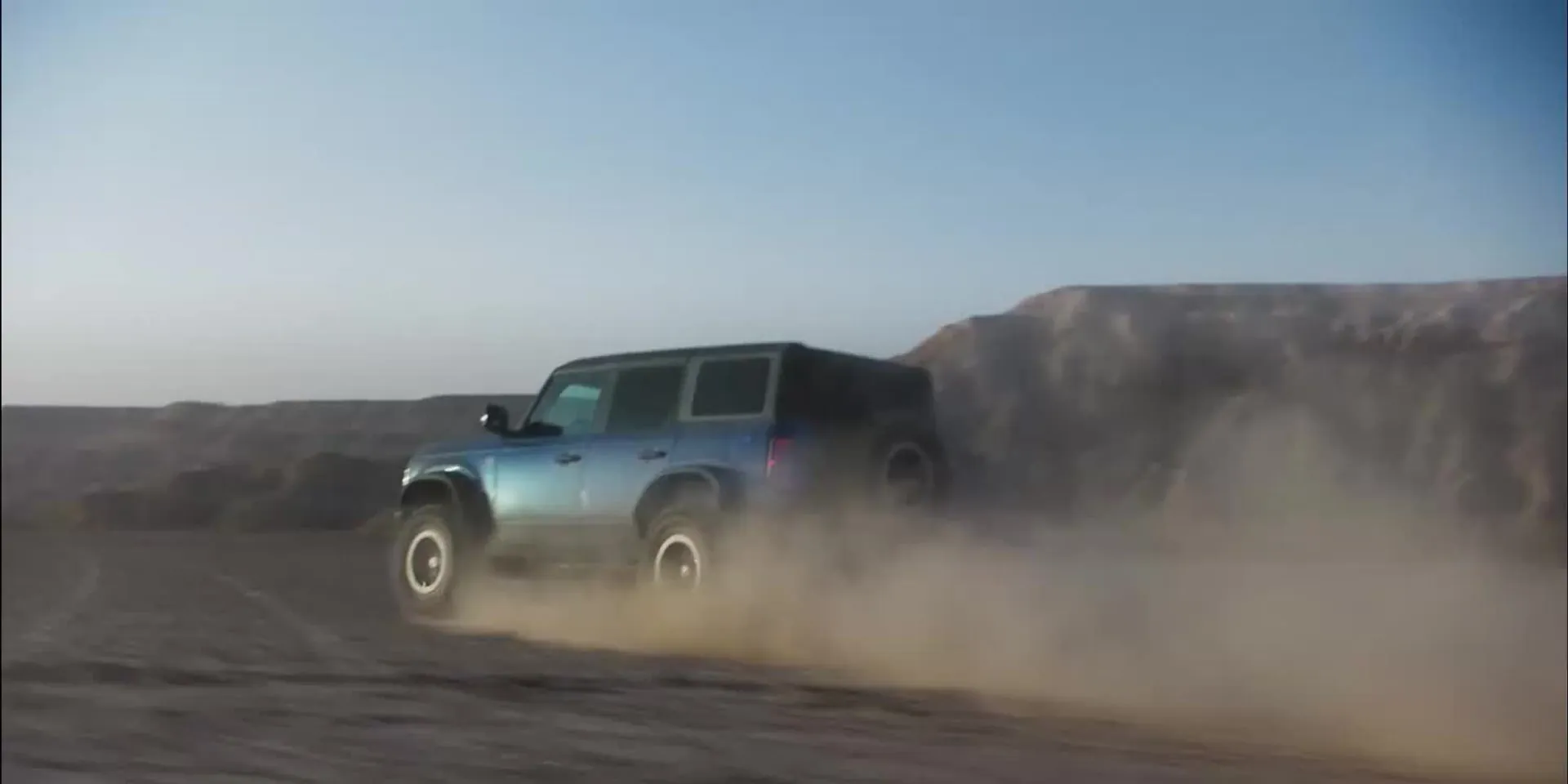 A Bronco crossing desert terrain