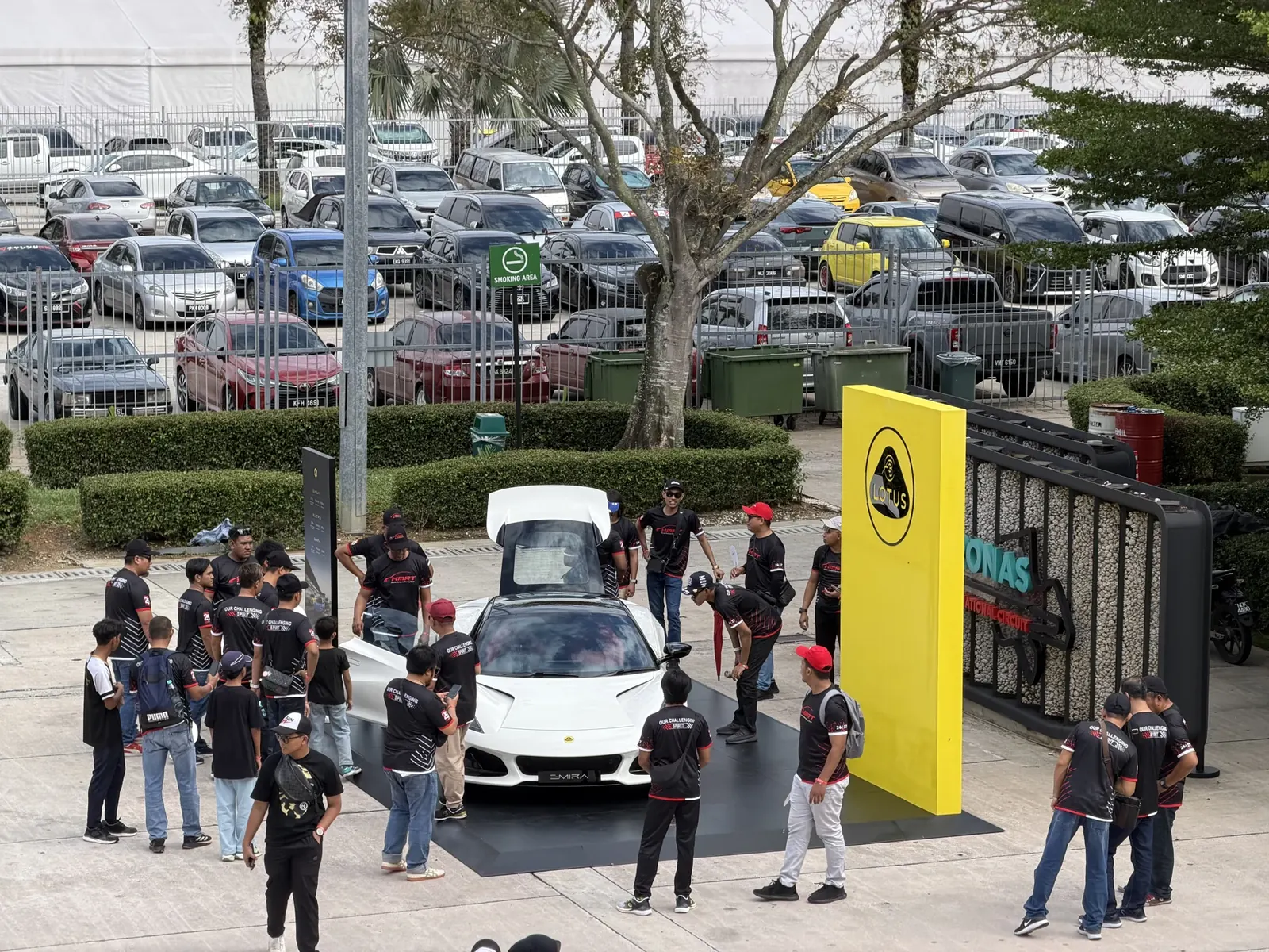 Visitors gathered around a Lotus sports car display at the circuit entrance